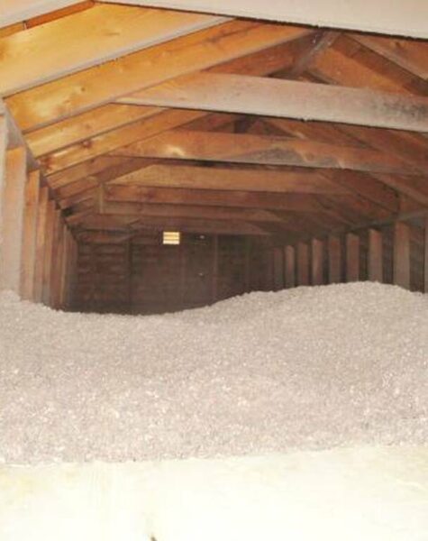 An old house attic was insulated with blow-in cellulose to protect against heat loss.