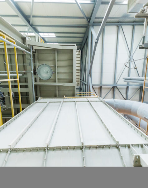 Down up view of modern operational plant with grey pipes and ladders heavy industry machinery metalworking workshop concept.