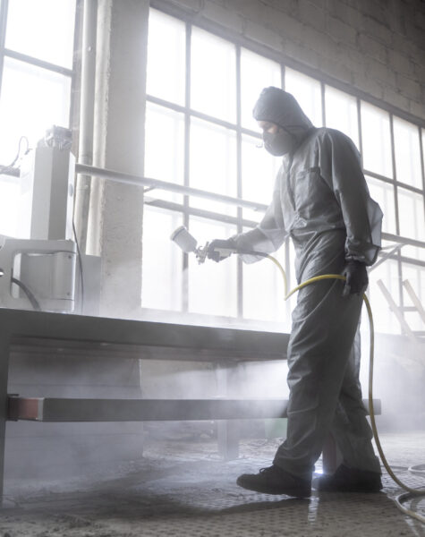 man-spraying-powder-paint-full-shot